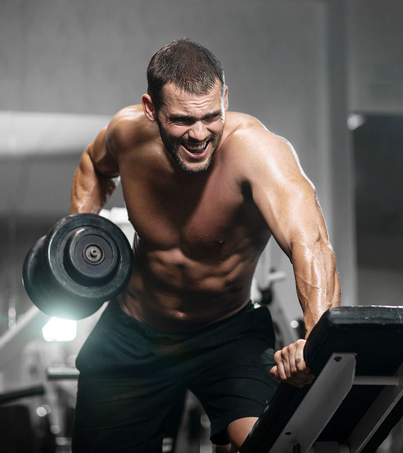 muscular guy doing dumbell back rows