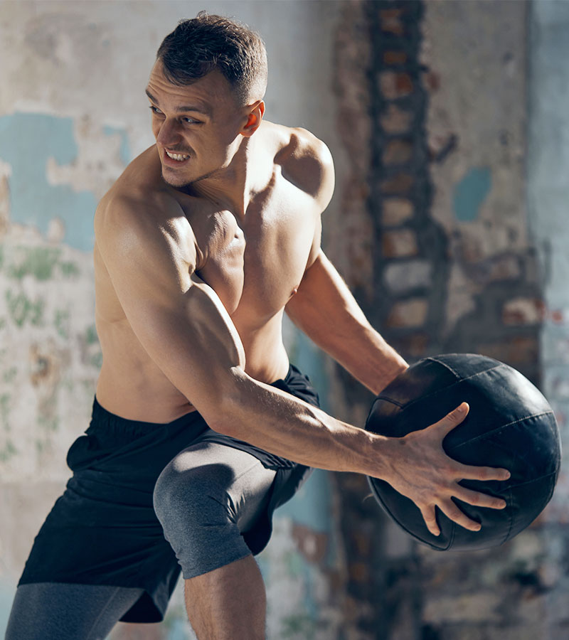 Muscular Guy Throwing a Medicine Ball