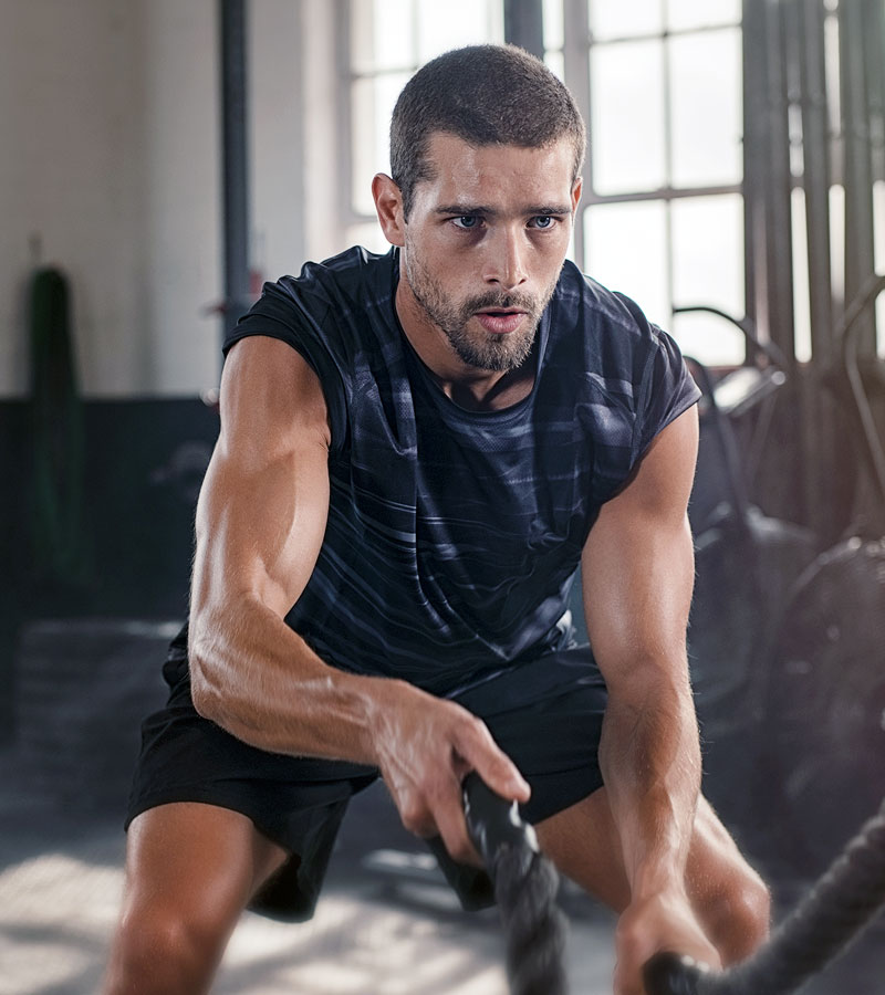 Muscular Guy in a Black Shirt doing Ropes