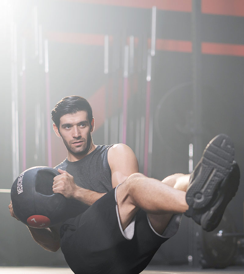 muscular guy holding a medicine ball