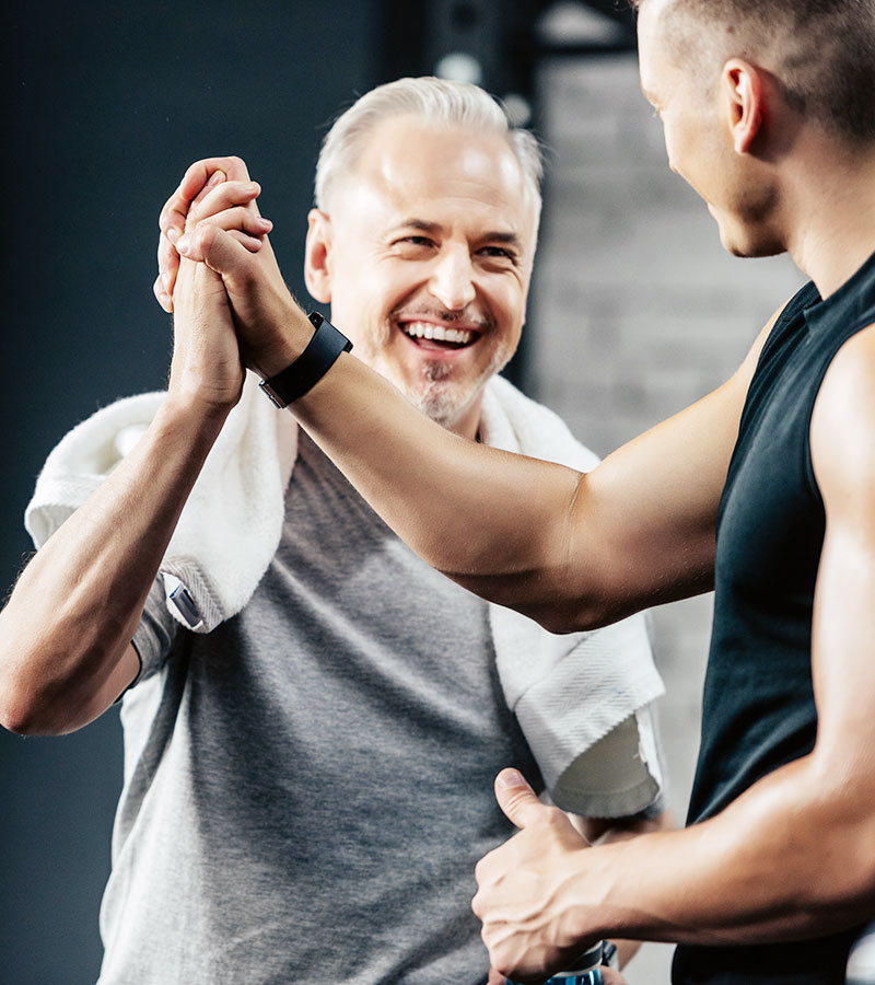 2 guys in the gym giving each other hive fives