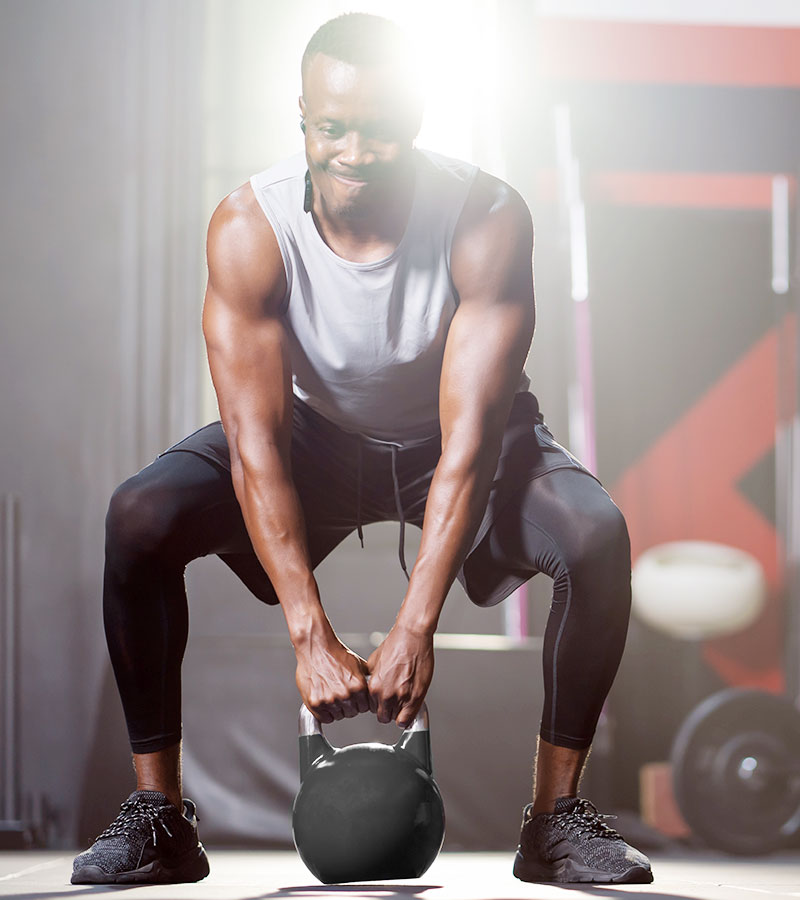 Muscular Guy doing the Kettle Ball Swing